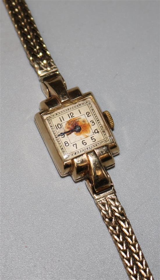 A ladys late 1940s 9ct gold J.W. Benson manual wind wrist watch, on a 9ct gold bracelet.